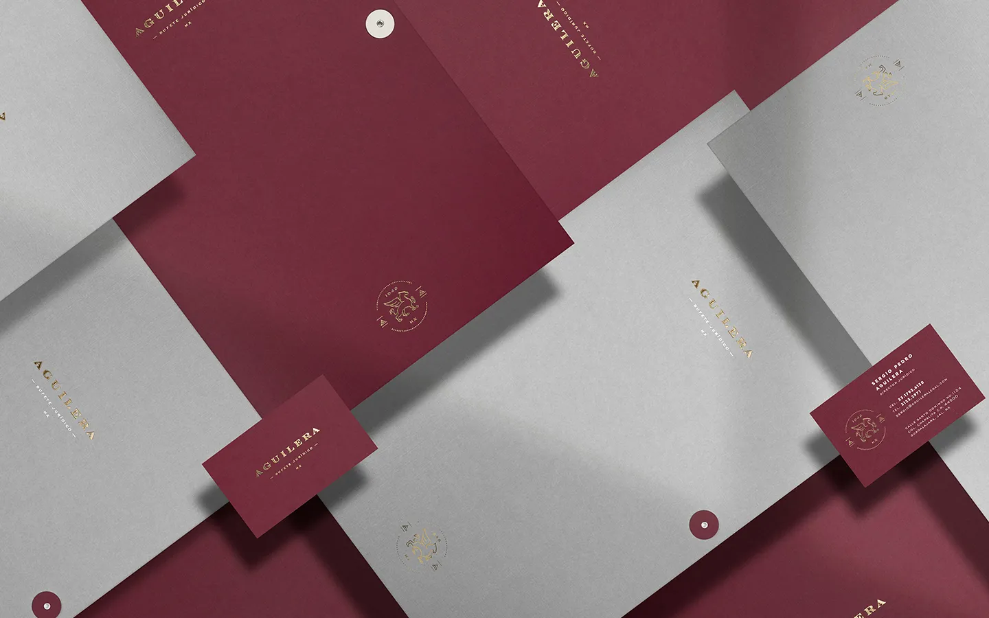 Aguilera identity applied to burgundy and white stationery with gold detailing.
