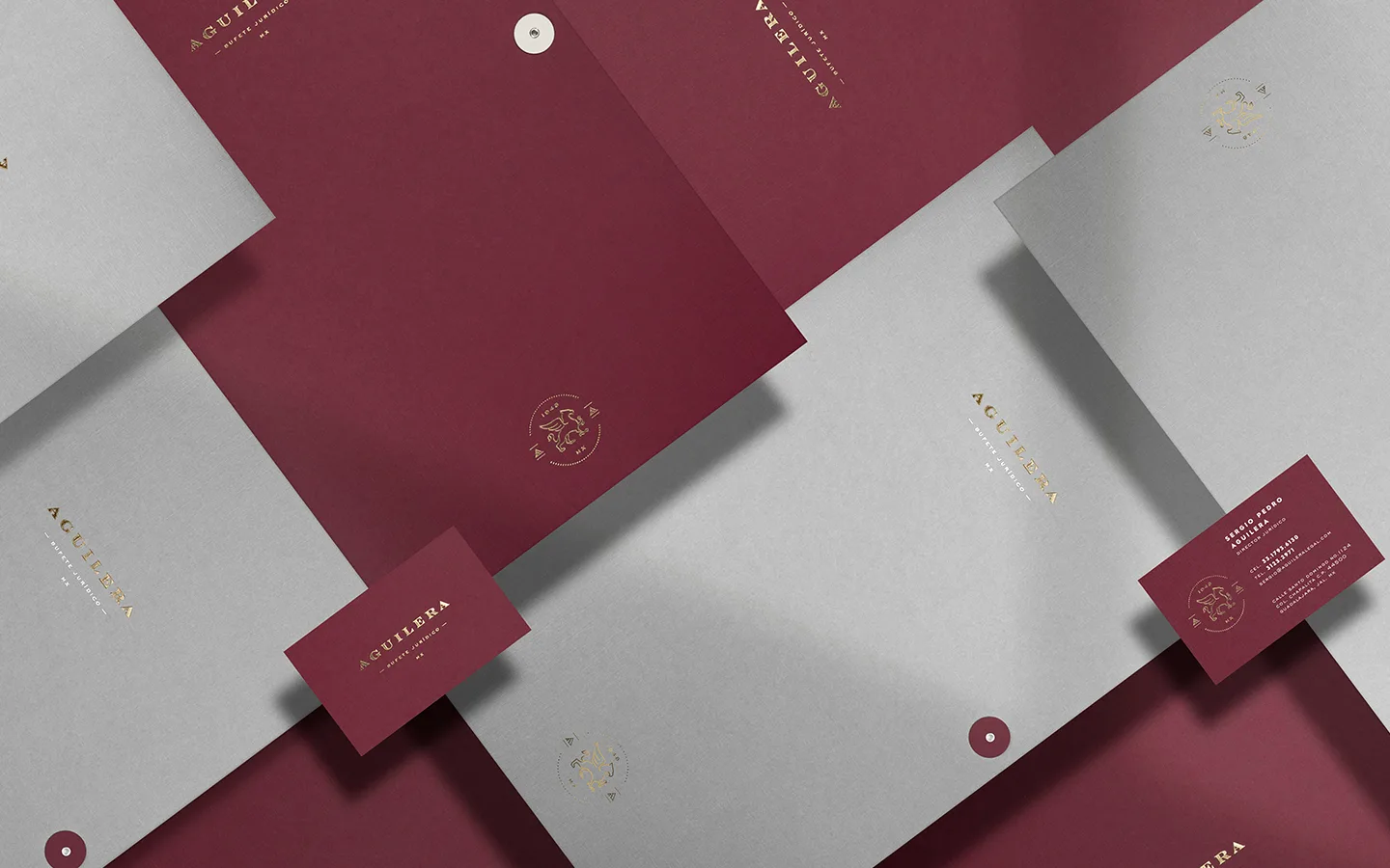 Aguilera identity applied to burgundy and white stationery with gold detailing.