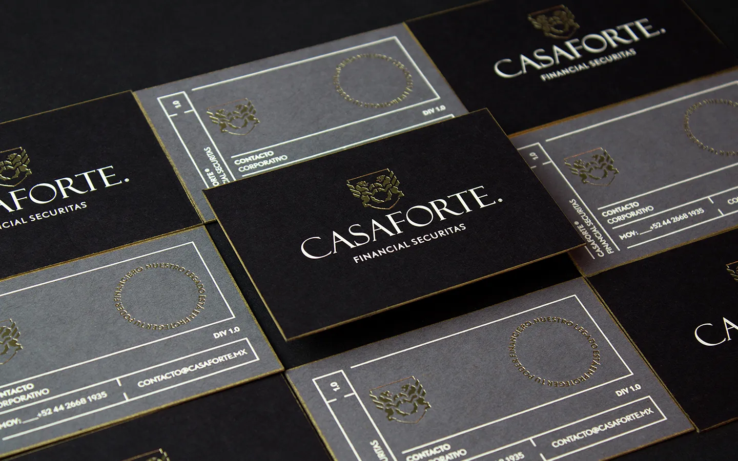 Black and grey Casaforte business cards with white typography and gold detailing.